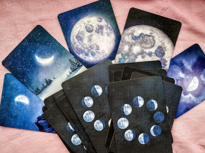 Tarot cards on a celestial moon-phase cloth — psychic readings